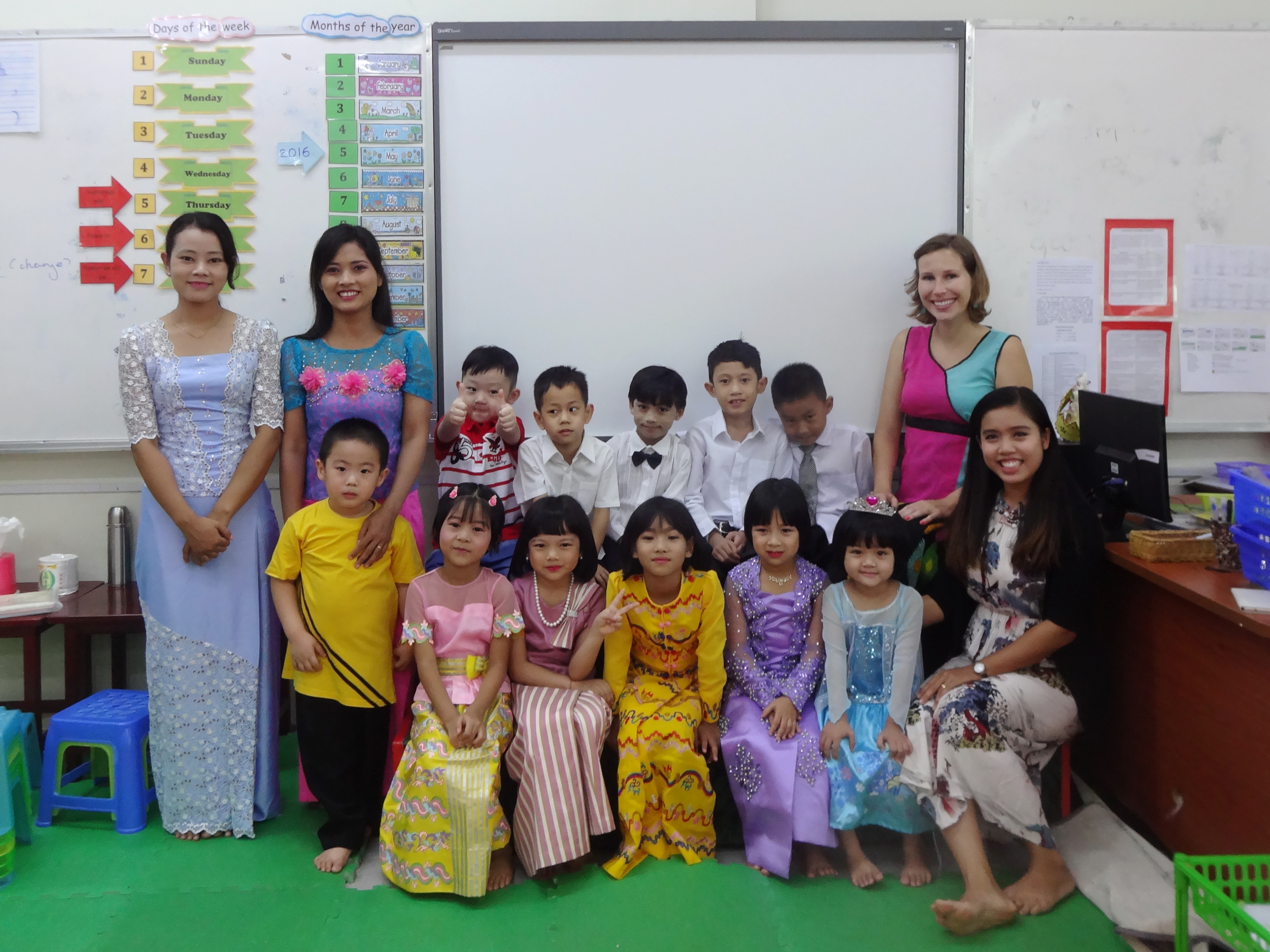 teaching English at a Montessori in Myanmar -KG graduation with some of our class, all dressed up in traditional Myanmar longyi